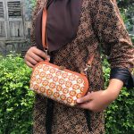 Elegant pandan weave sling bag with a compact and stylish design, perfect for a sophisticated look and everyday use.